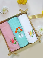 Gift box with three embroidered waffle hand towels in pink, mint green and white
