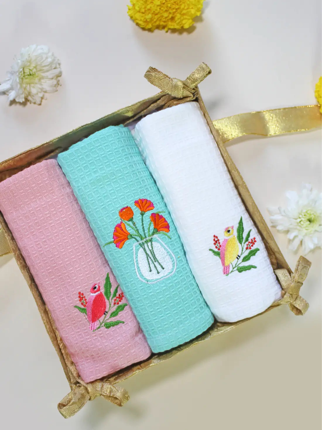 Gift box with three embroidered waffle hand towels in pink, mint green and white