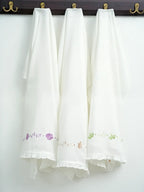 Floral Frills set of three white embroidered Kerala Thorthu towels hanging on hooks