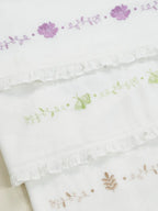 Purple, green and beige floral embroidery on white ruffled Thorthu towels