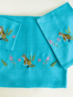 Teal blue waffle bath, hand and face towels with tiger and pink floral embroidery