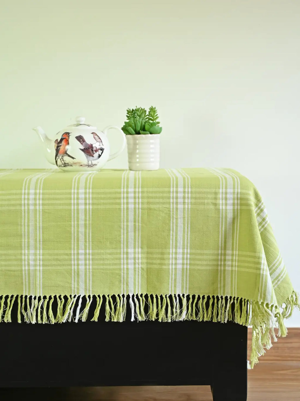 Light green and white plaid tablecloth with a fringed edge