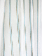 Close-up of narrow powder blue stripes on white sheer curtain fabric
