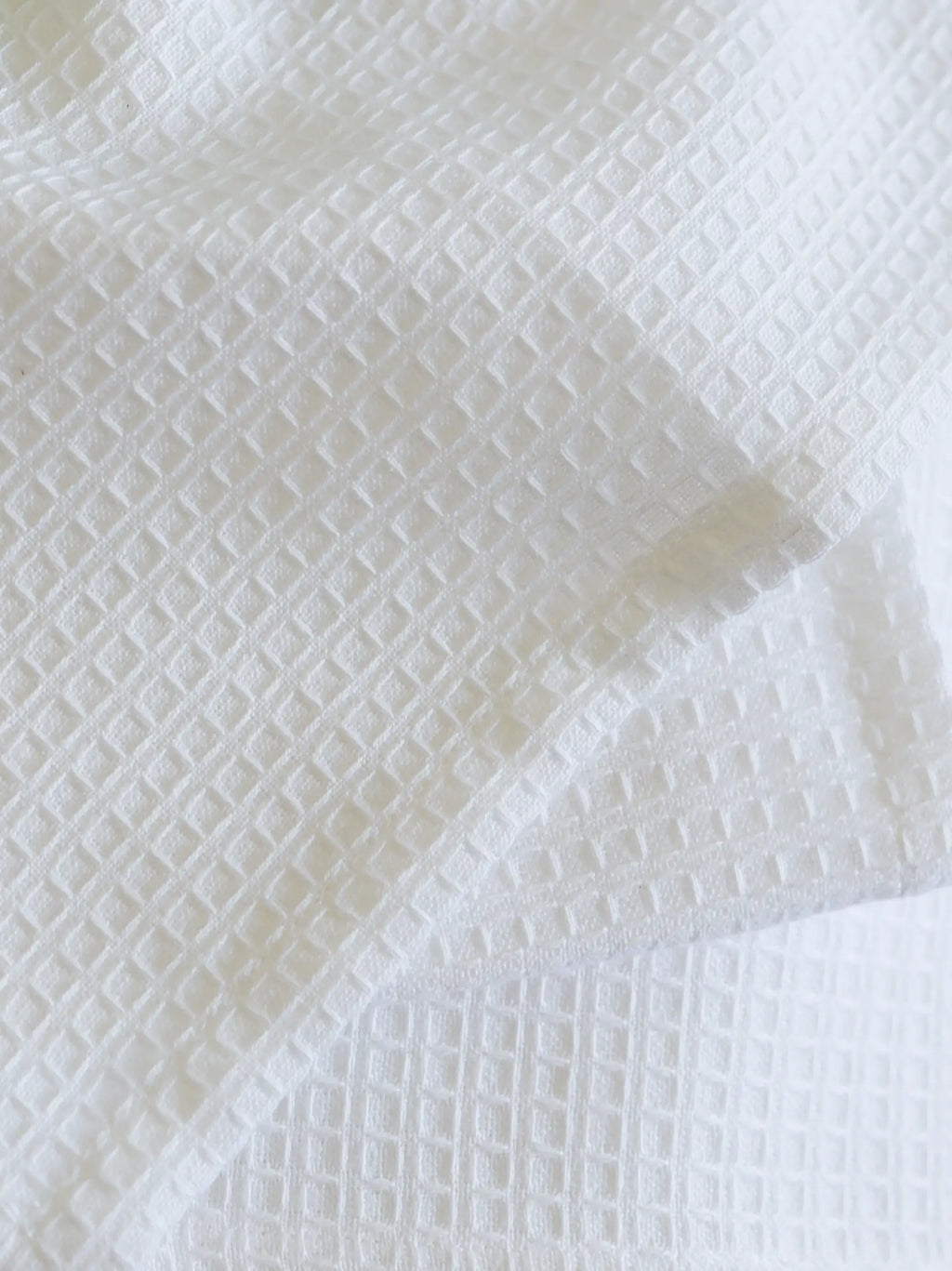 Close-up of the square waffle weave on a white towel