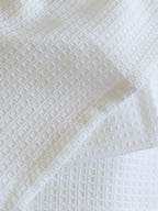 Close-up of the square waffle weave on a white towel