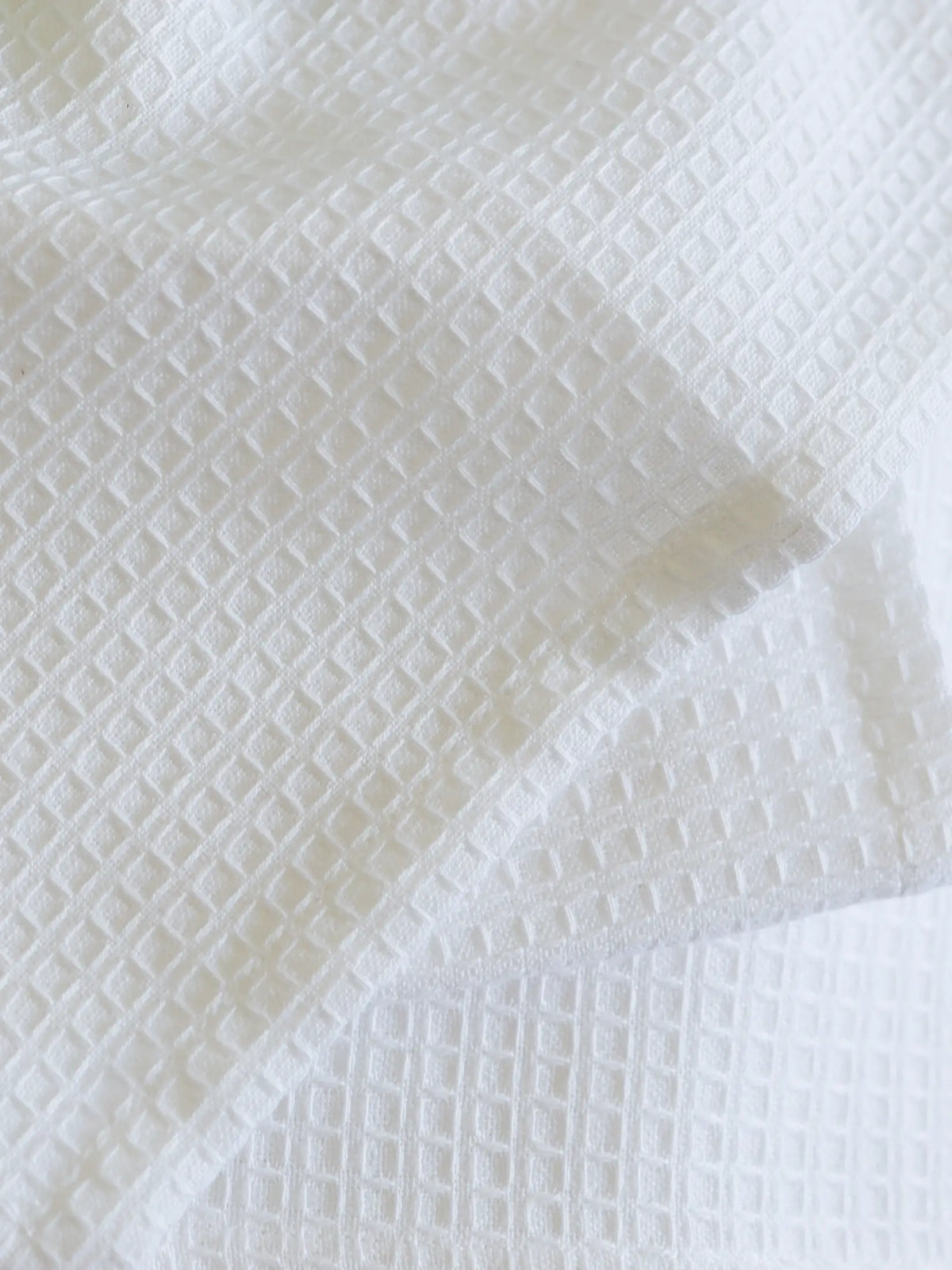Close-up of the square waffle weave on a white towel